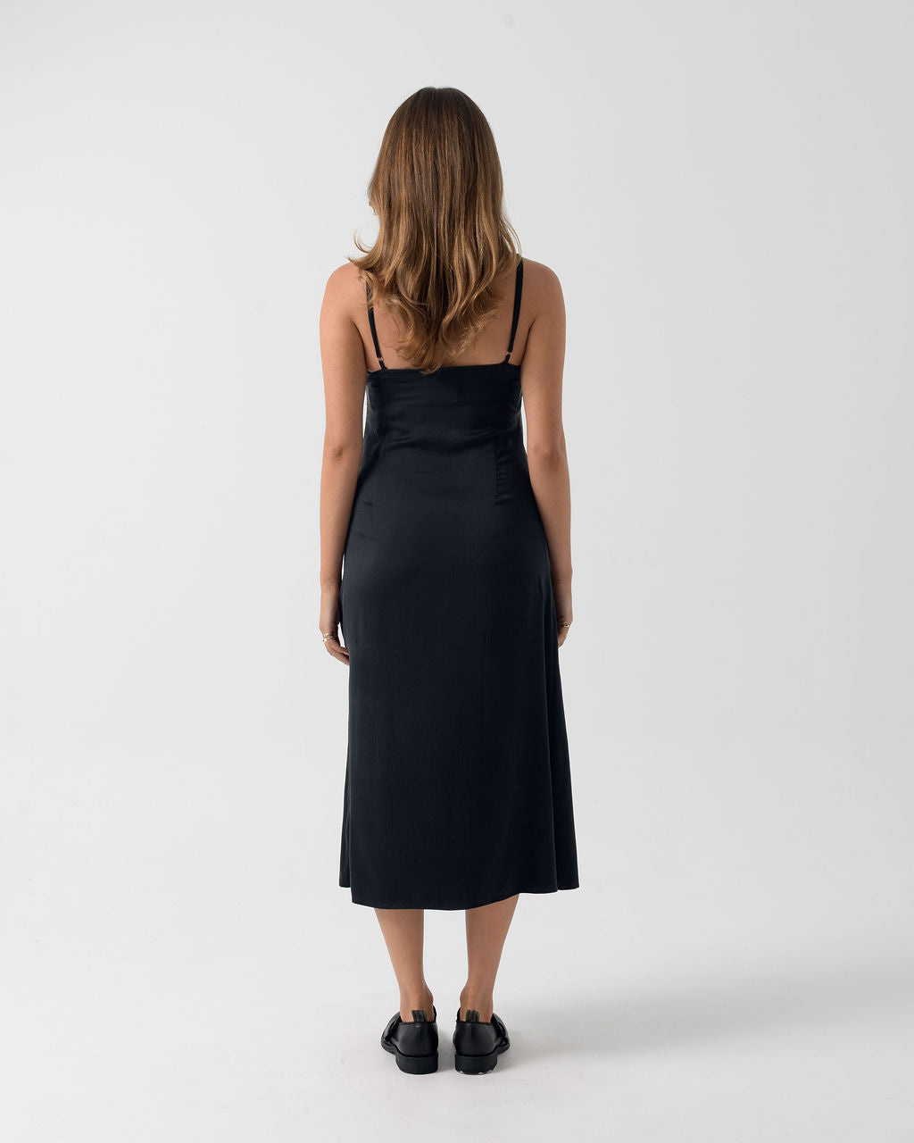 Full back view of the Washed Black Bias Slip Dress in stonewashed stretch silk with a fluid bias-cut silhouette.