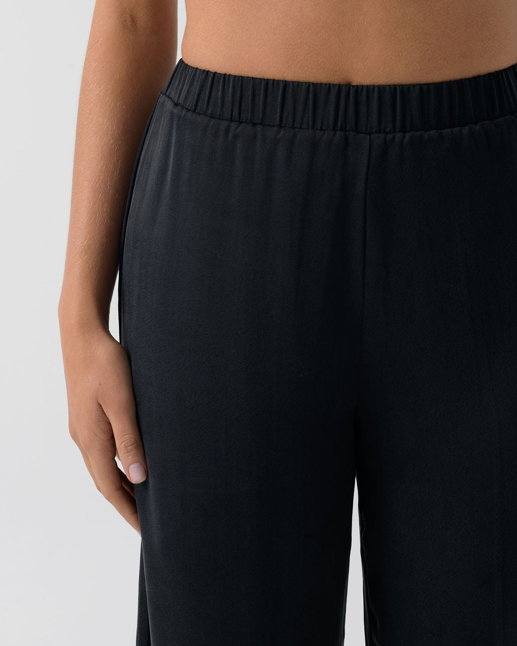Close-up of the Washed Black Classic Wide Leg Pant highlighting the smooth front and fluid wide-leg silhouette.