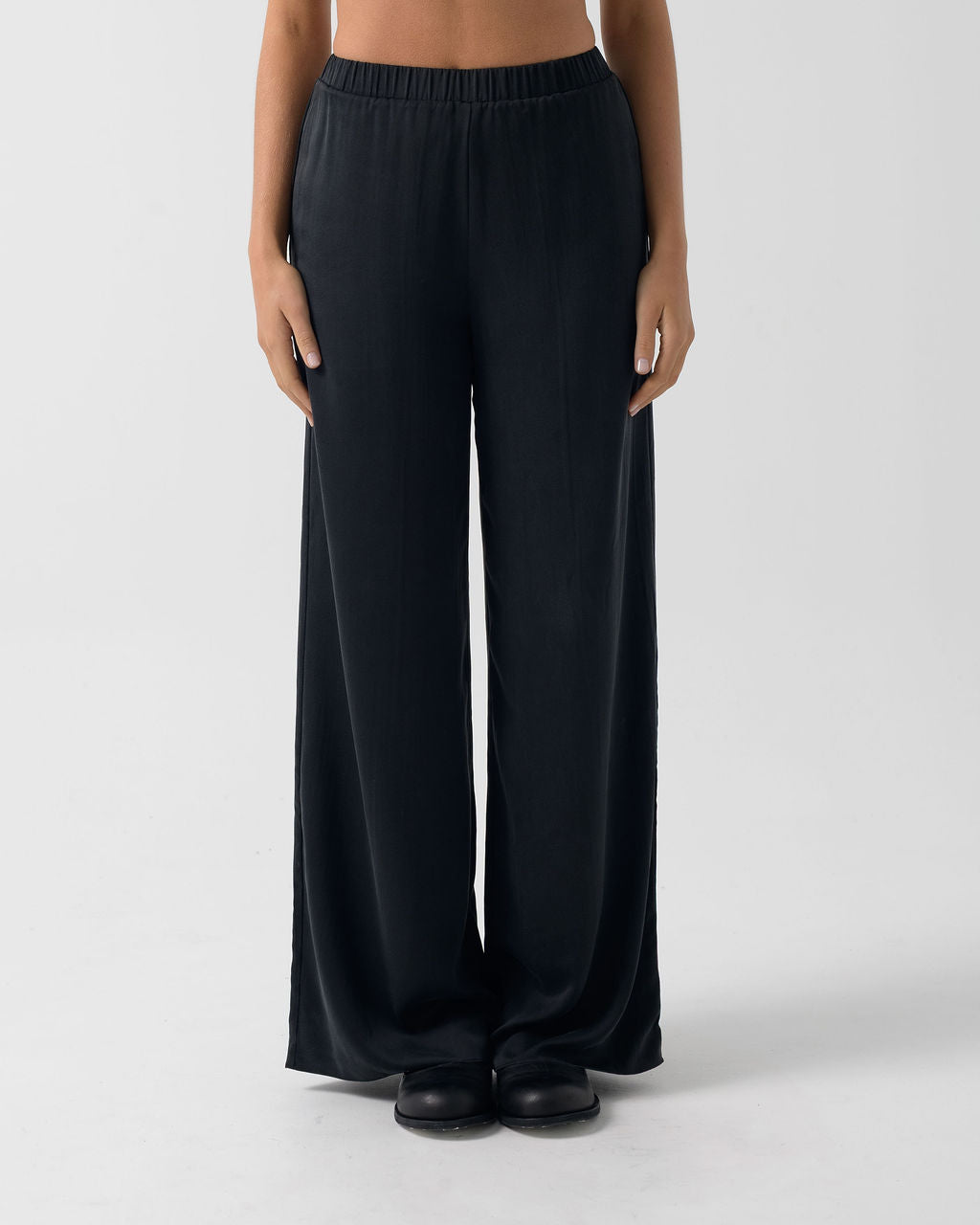 Front view of the Washed Black Classic Wide Leg Pant featuring a fluid wide-leg fit and elastic waistband.