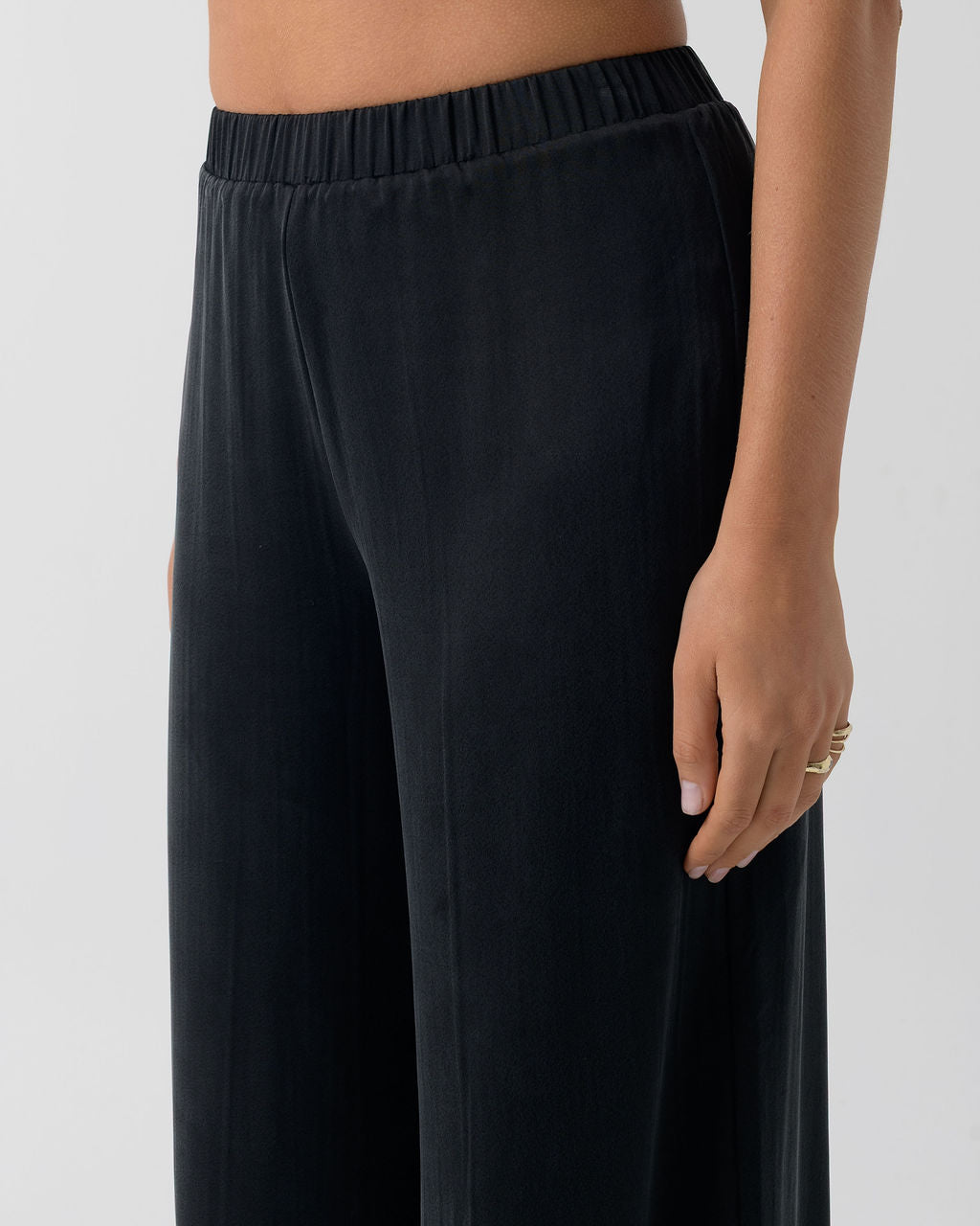 Close-up of the Washed Black Classic Wide Leg Pant showing the elastic waistband and stonewashed stretch silk fabric.