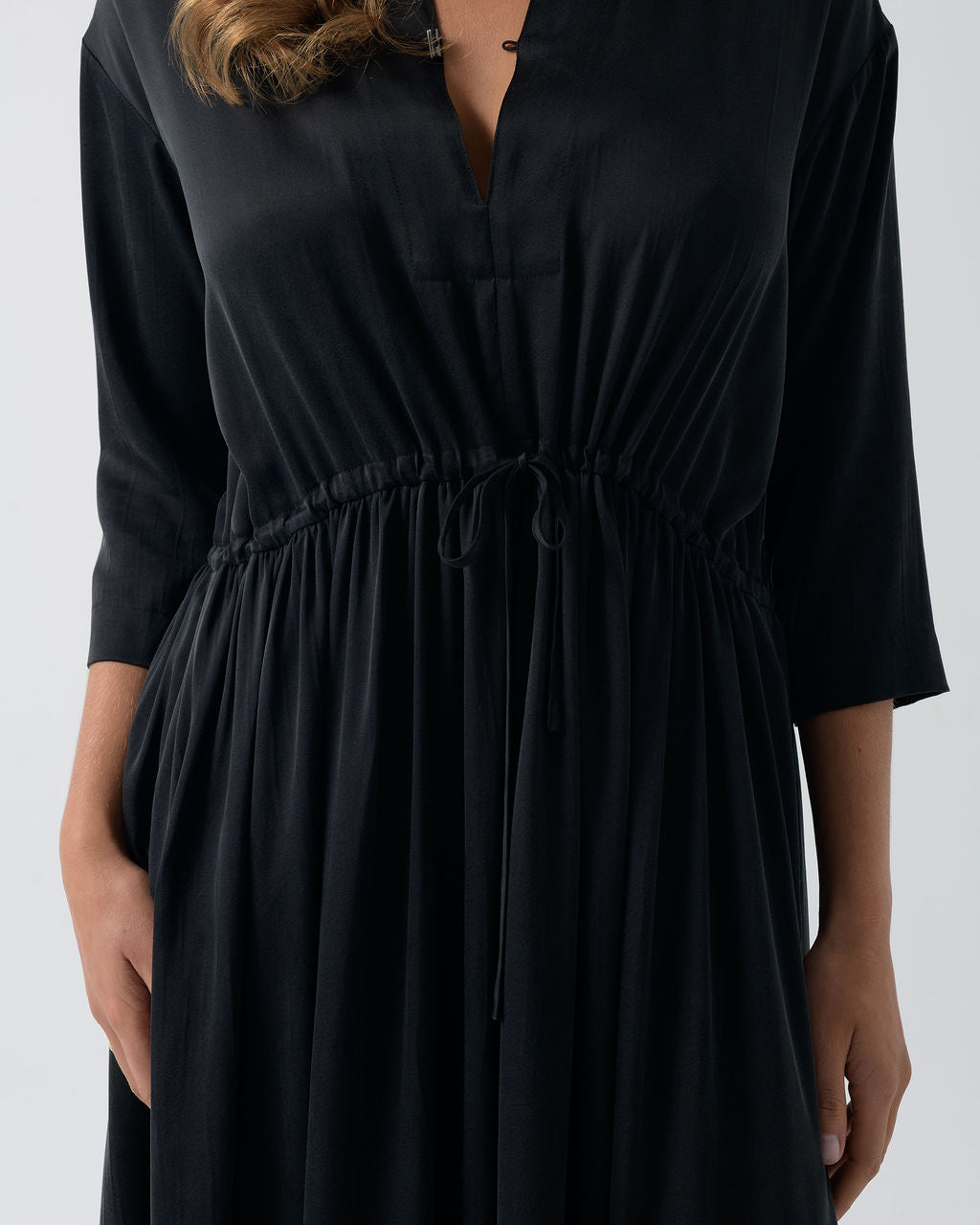 Close-up of the Washed Black Drawstring Dress showing the adjustable drawstring waist and stonewashed stretch silk fabric.