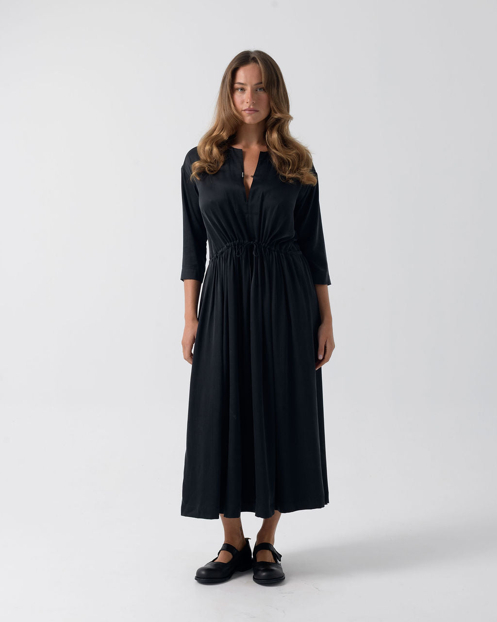 Model wearing the Washed Black Drawstring Dress in stonewashed stretch silk with a relaxed fit and full-length silhouette.