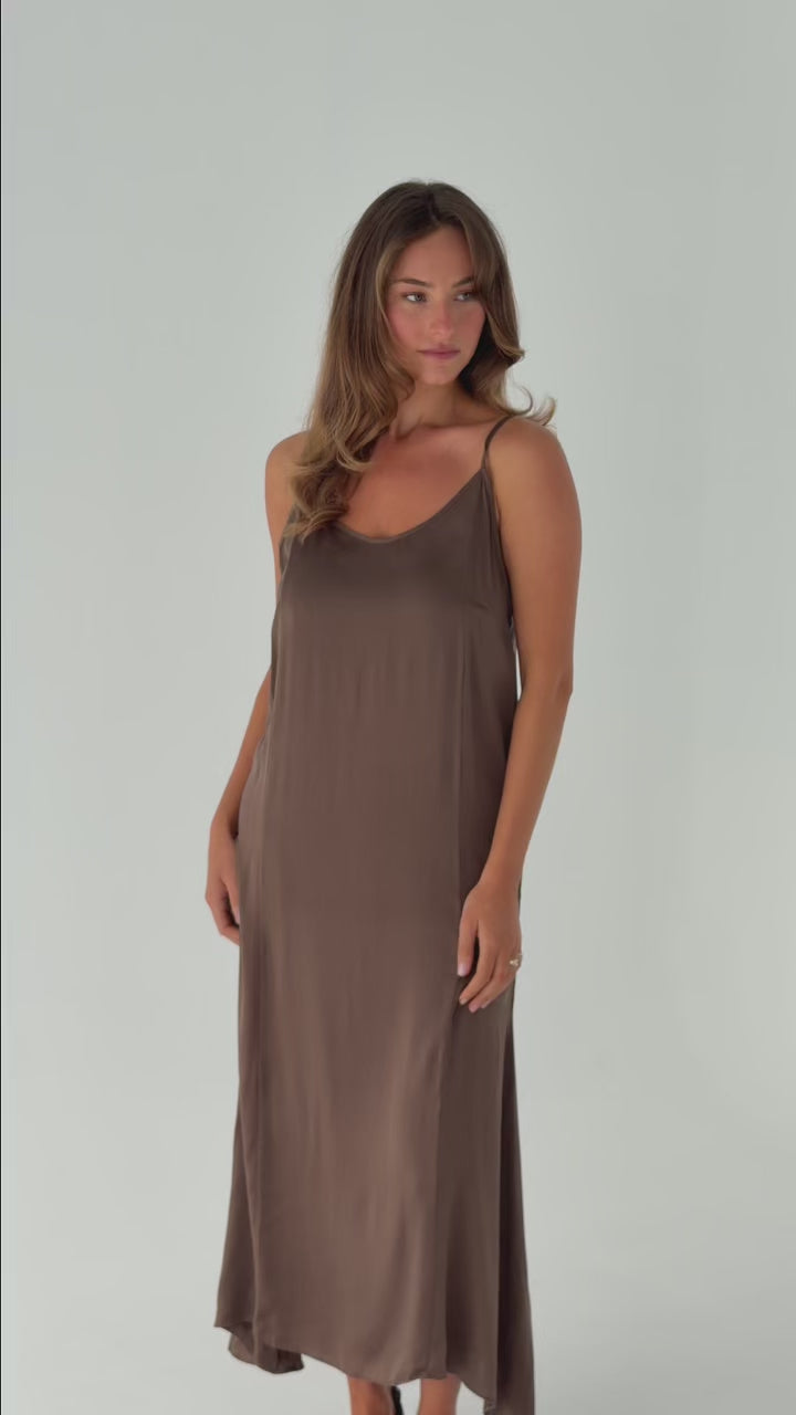 Model wearing the Moka Signature Slip Dress in stonewashed stretch silk, showcasing the fluid full-length silhouette, adjustable straps and effortless movement.