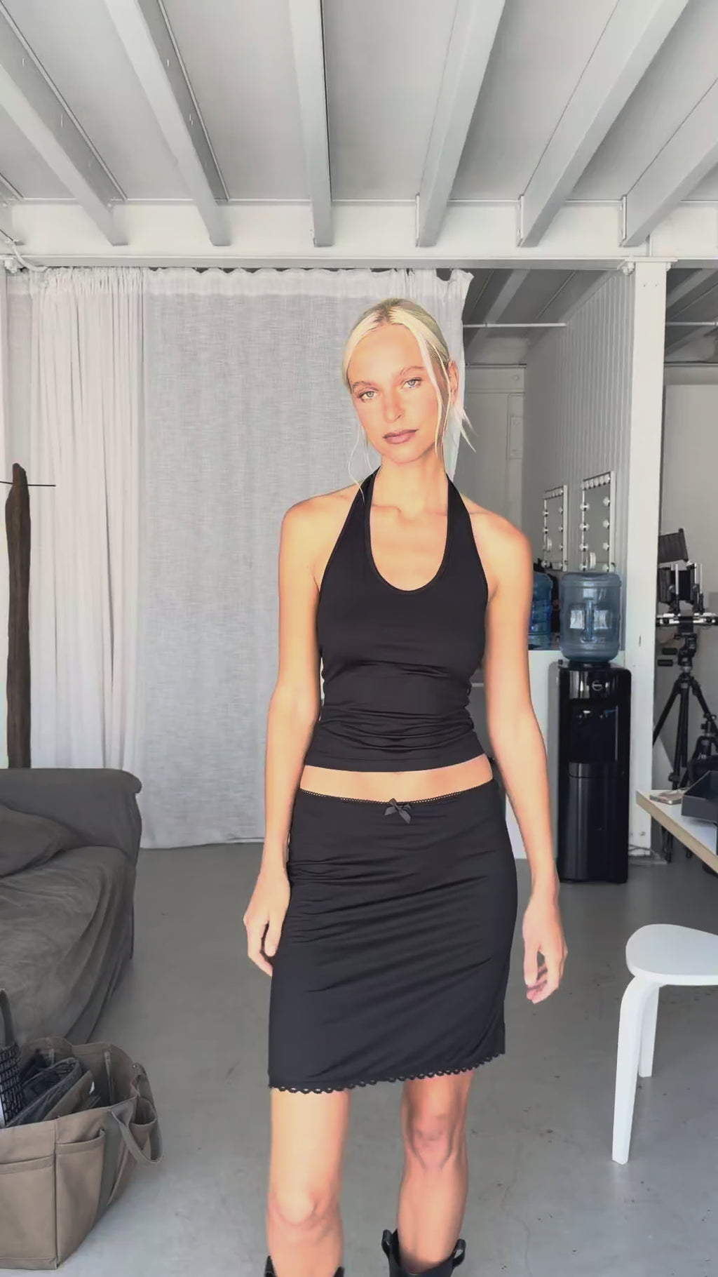 Video showing the silk jersey halter top styled with the silk jersey mini skirt, highlighting the fitted silhouette and fluid movement of the silk jersey fabric.