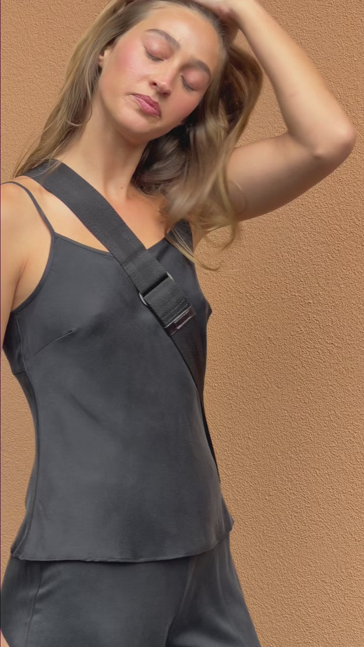 Model wearing the Washed Black Camisole in stonewashed stretch silk with a relaxed drape, thin adjustable straps and a classic 90s-inspired silhouette.
