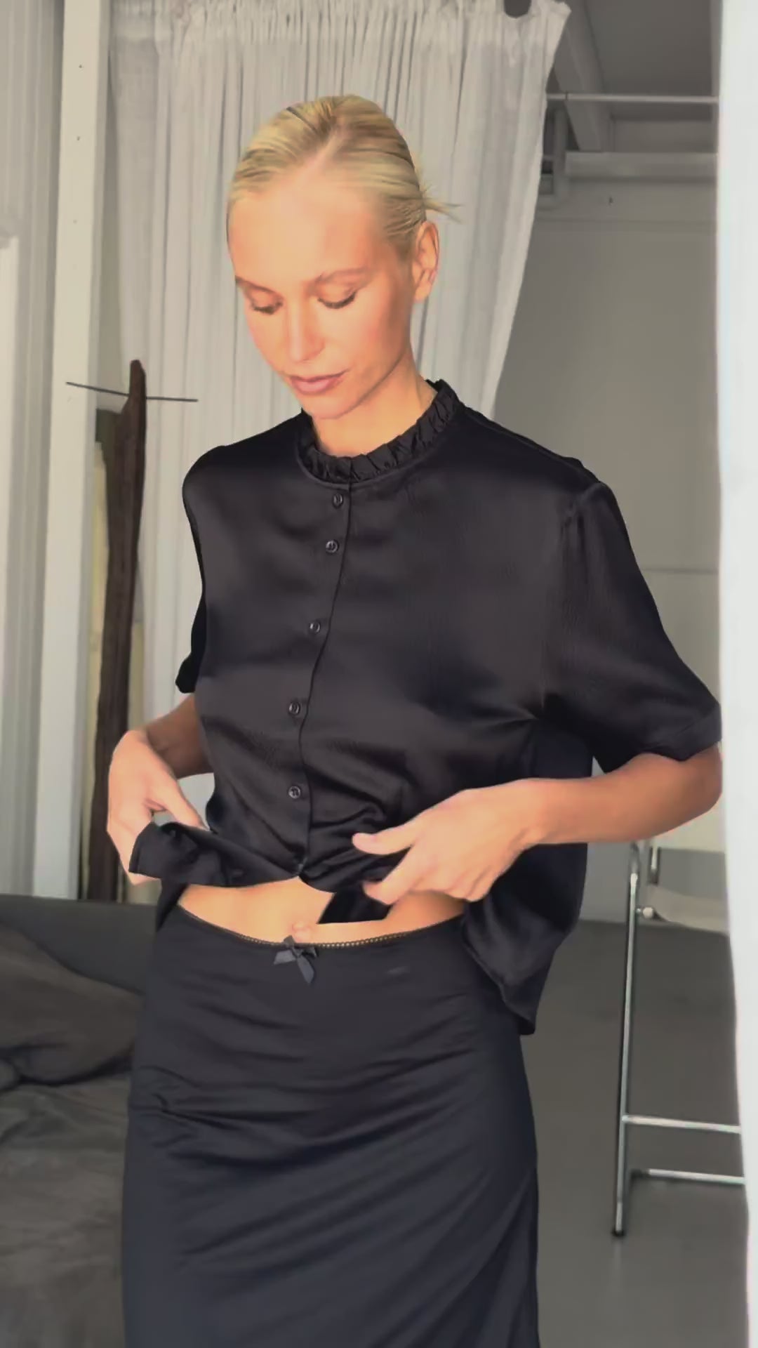 Video showing the hammered silk frill shirt worn by model Katia, highlighting the boxy short sleeve fit, delicate frill neckline, and textured drape of the silk fabric.