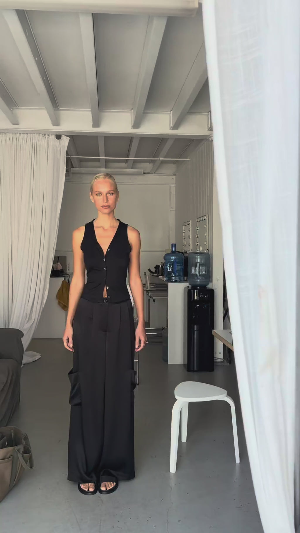 Video showing the cargo trousers styled with the silk jersey vest top, highlighting the high waist fit, wide leg silhouette, and relaxed movement.