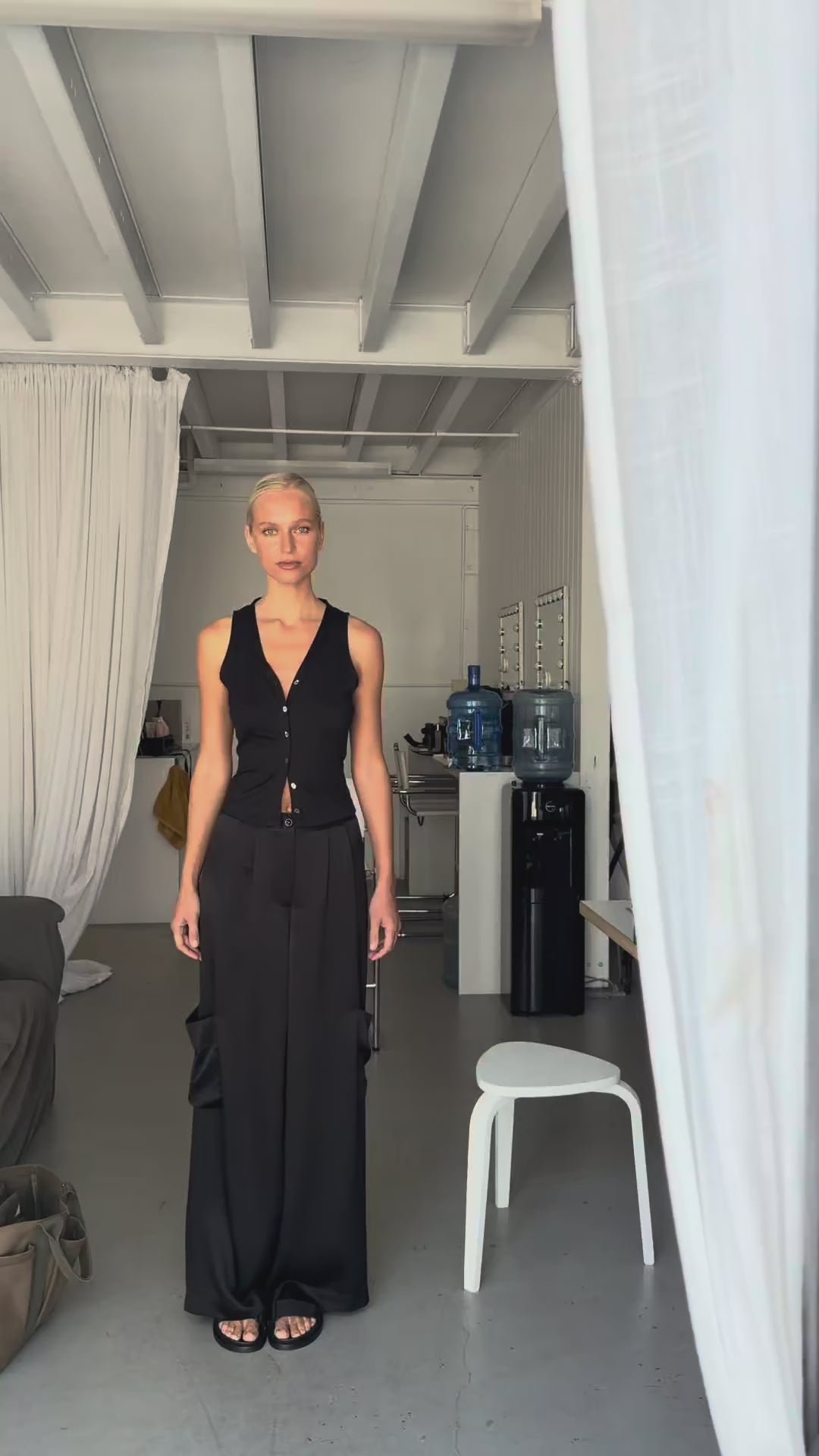 Video showing the cargo trousers styled with the silk jersey vest top, highlighting the high waist fit, wide leg silhouette, and relaxed movement.
