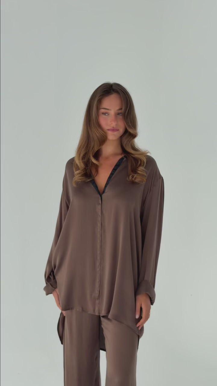 Model wearing the Hazelnut Oversized Silk Shirt in stretch silk with a relaxed fit, press-stud closures and a fluid drape.