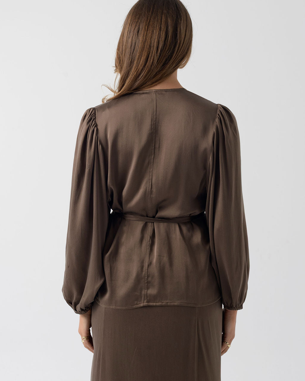 Back view of the Moka Wrap Blouse in stonewashed stretch silk with gathered sleeves and a waist tie.