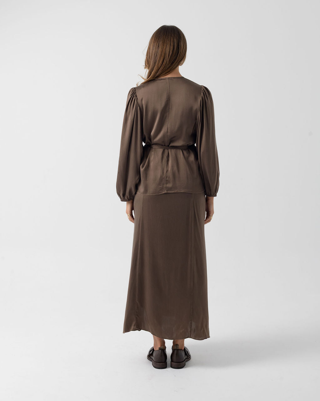 Full back view of the Moka Wrap Blouse in stretch stonewashed silk with billowed sleeves and a relaxed fit.
