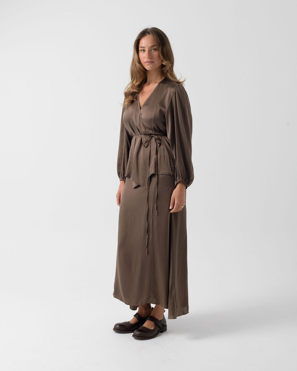 Side view of the Moka Wrap Blouse in stretch stonewashed silk with a wrap silhouette and flowing drape.